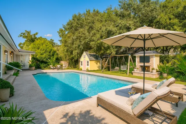 a view of a swimming pool with a patio