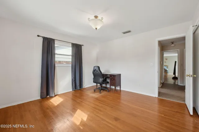 a view of a workspace with wooden floor and a workspace