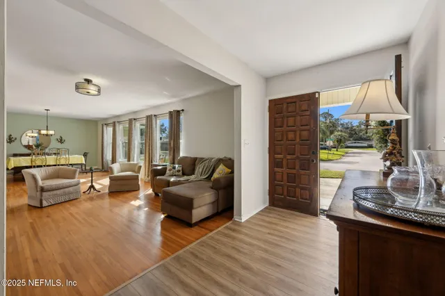 a bedroom with furniture and a large window