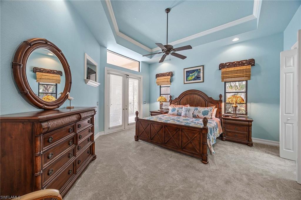 146 Windward Cay Naples, FL 34114 - Photo 14 of 33 a spacious bedroom with a bed and a dresser