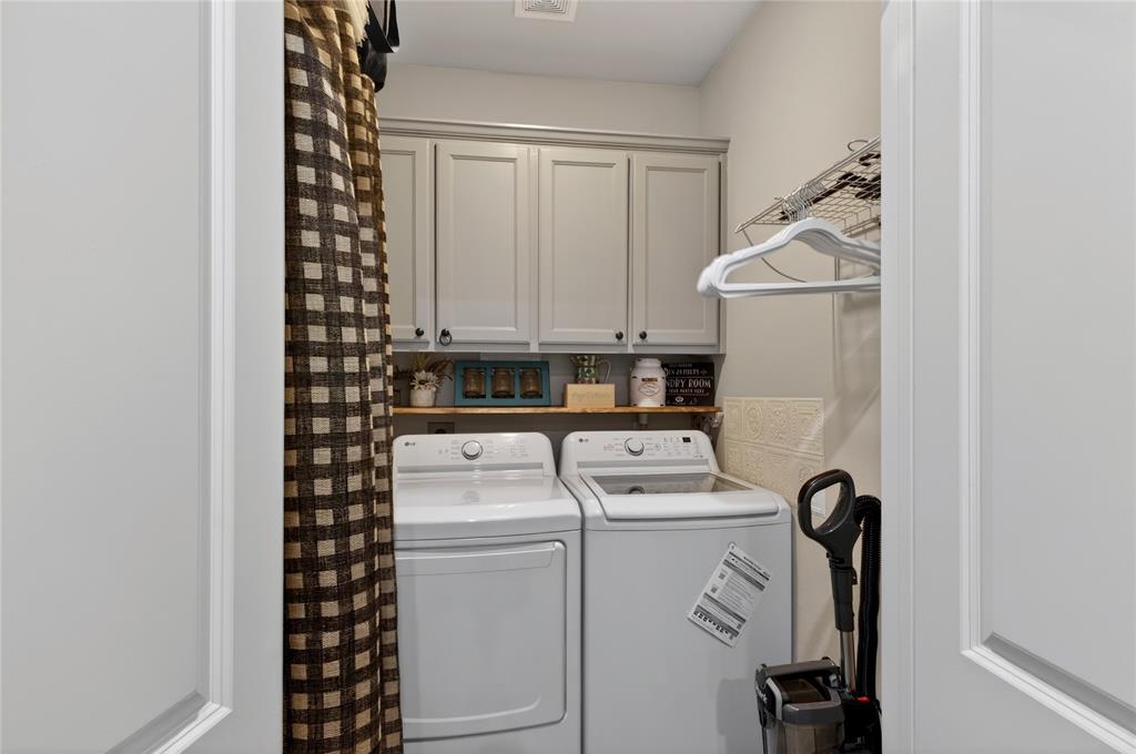 701 West Lamberth Road Sherman, TX 75092 - Photo 21 of 37 Dedicated laundry area featuring light gray cabinetry, wood shelving, and a wire drying rack