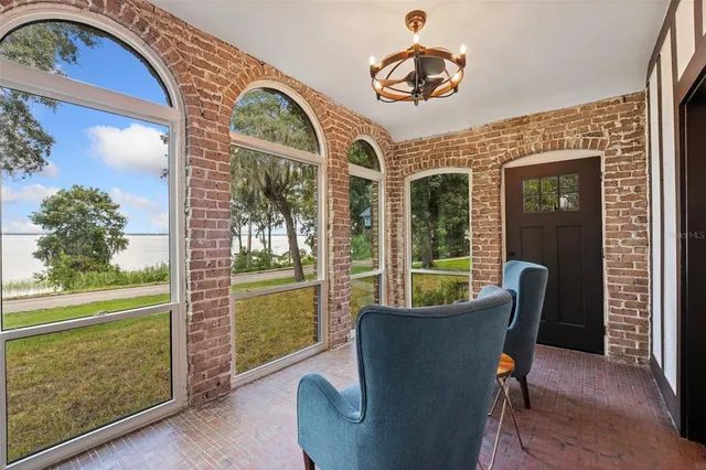 a view of wooden floor and windows in a room