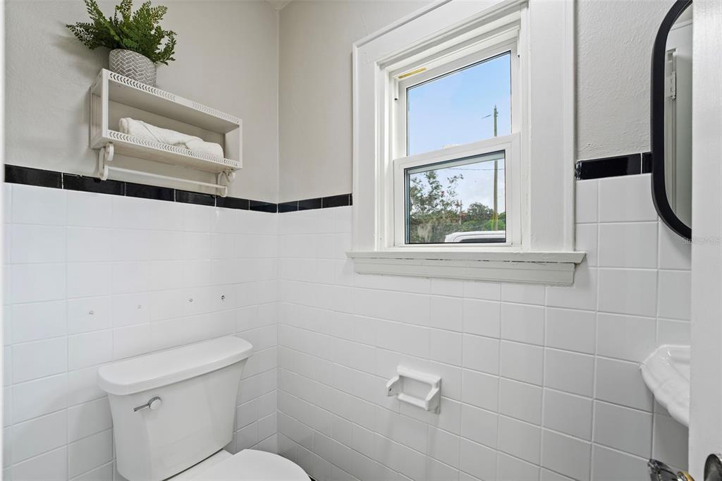 1689 Lakeshore Drive Eustis, FL 32726 - Photo 40 of 76 a bathroom with a toilet a sink and a window