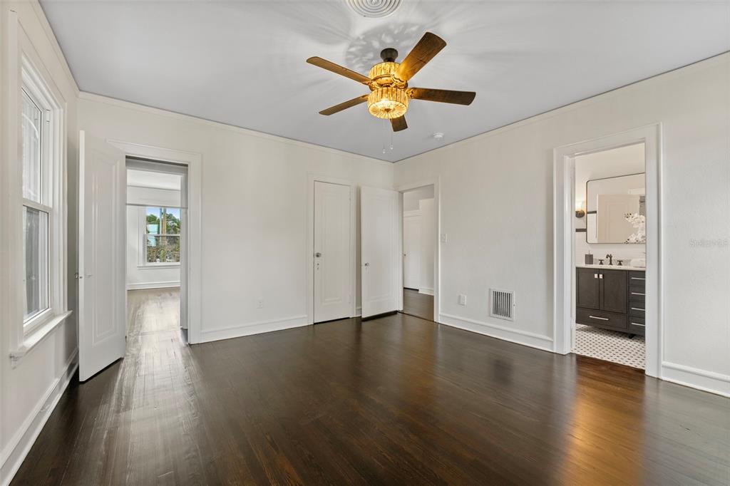 1689 Lakeshore Drive Eustis, FL 32726 - Photo 55 of 76 a view of an empty room with wooden floor and a ceiling fan