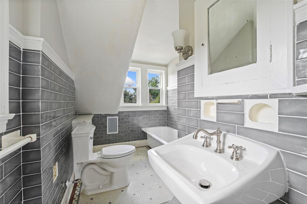 1689 Lakeshore Drive Eustis, FL 32726 - Photo 56 of 76 a bathroom with a sink a toilet and mirror