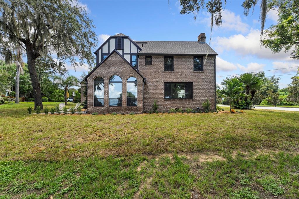 1689 Lakeshore Drive Eustis, FL 32726 - Photo 6 of 76 a front view of a house with a garden