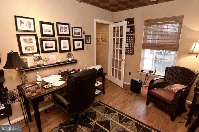 a living room with furniture and paintings on the wall
