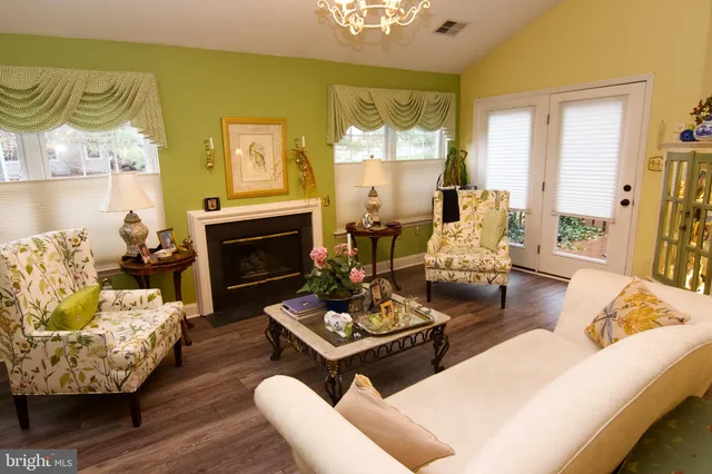 a living room with furniture fireplace and a table