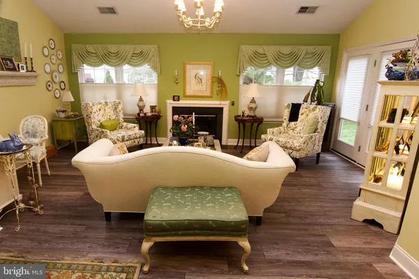 a living room with fireplace furniture and a chandelier