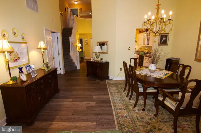 a dining room with furniture and wooden floor