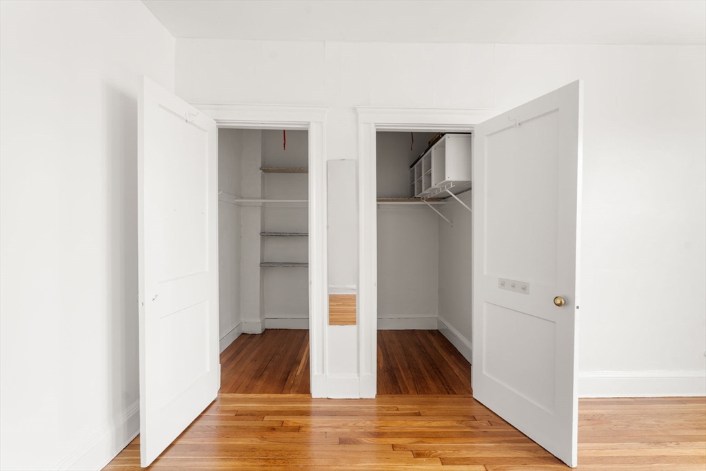 97 Chester Street, Unit 8 Boston, MA 02134 - Photo 16 of 19 a view of a livingroom with wooden floor and a hallway