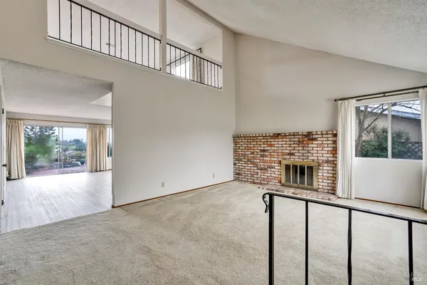 a view of empty room with a fireplace