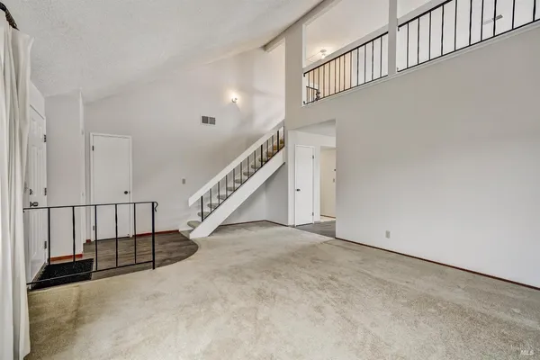 a view of a room with wooden floor and balcony