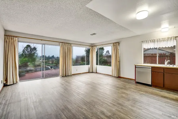 a view of a room with wooden floor and doors