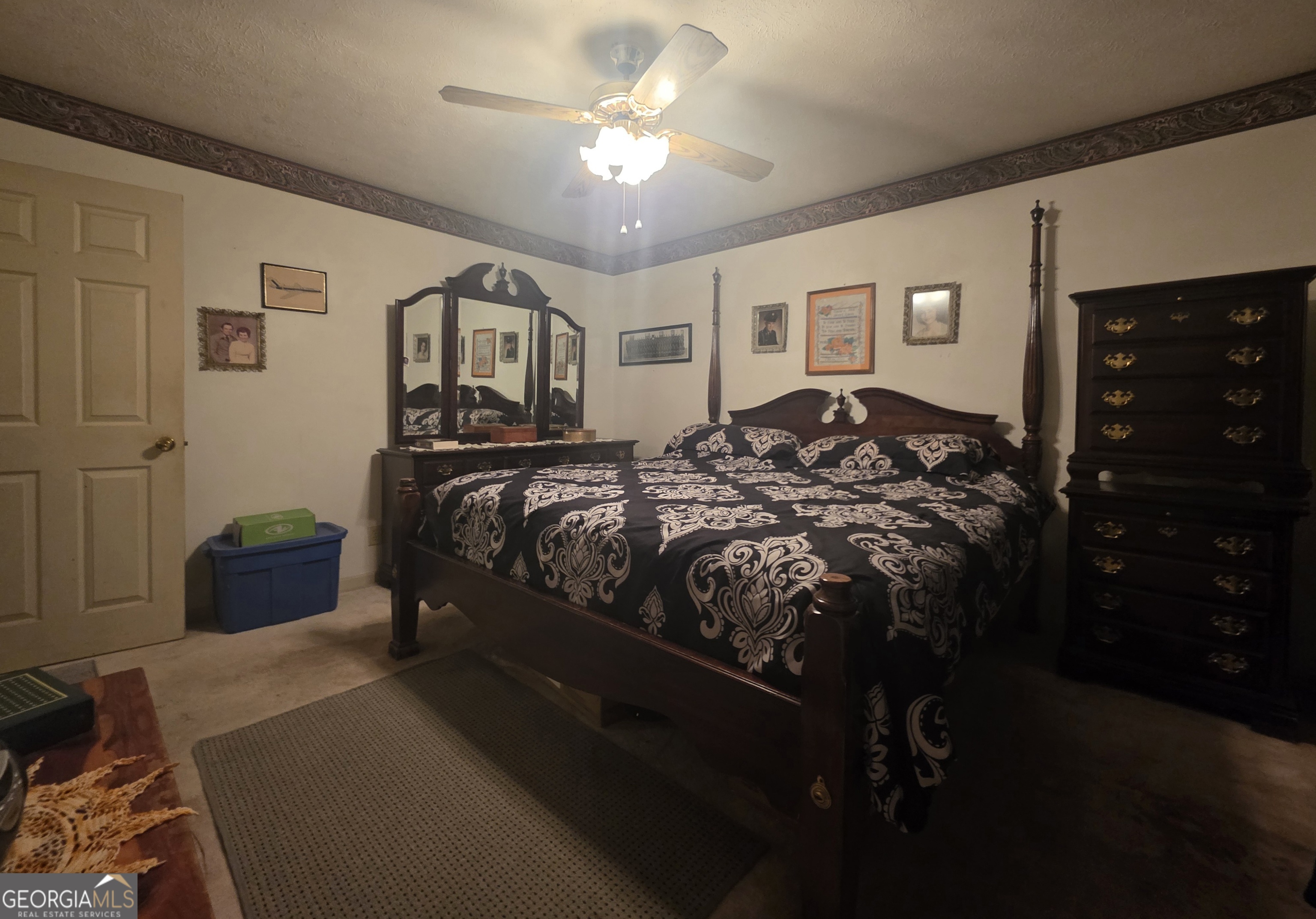 1407 Rainbow Circle Griffin, GA 30224 - Photo 12 of 23 a bedroom with a bed and a chandelier