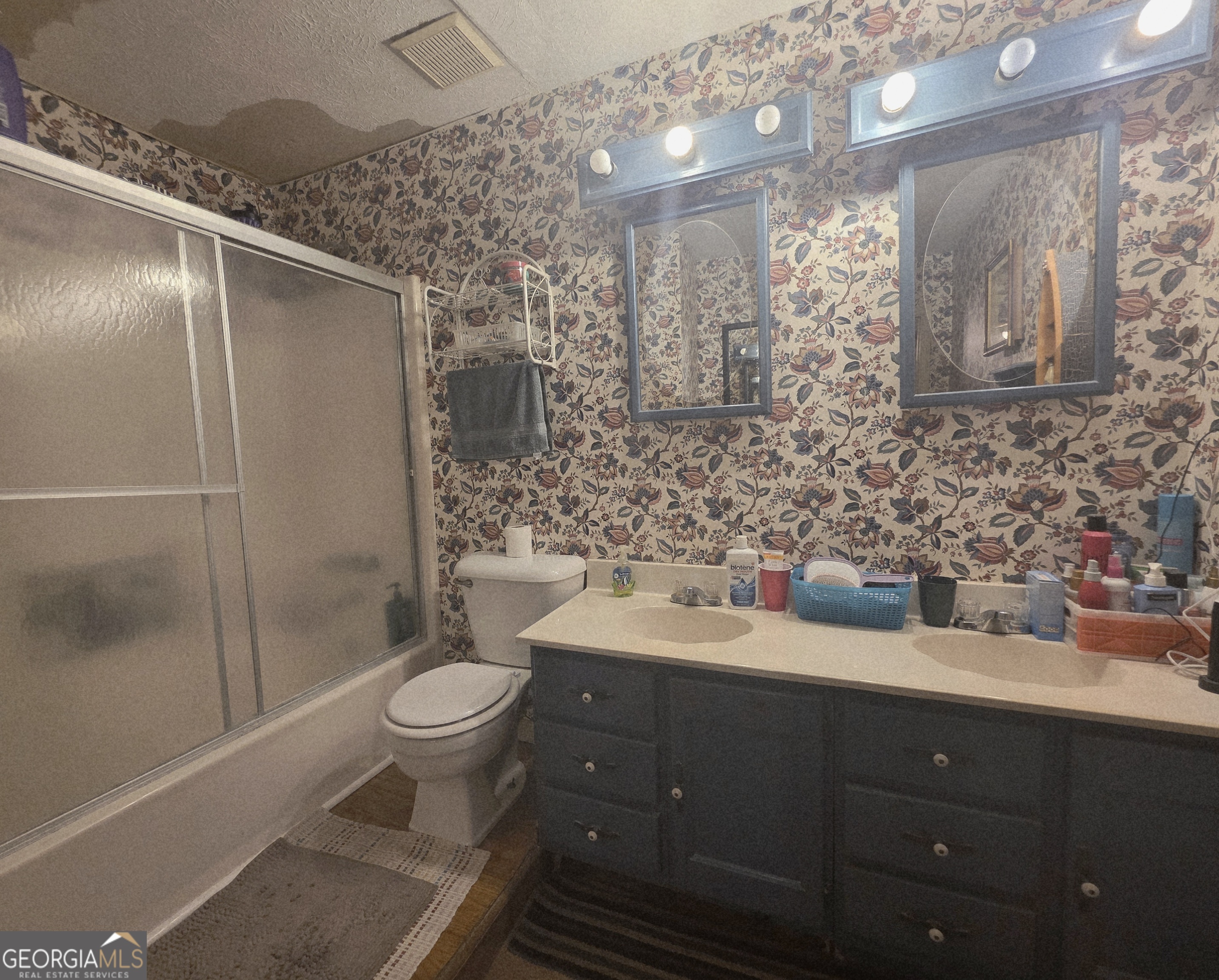 1407 Rainbow Circle Griffin, GA 30224 - Photo 14 of 23 a bathroom with a toilet sink and mirror