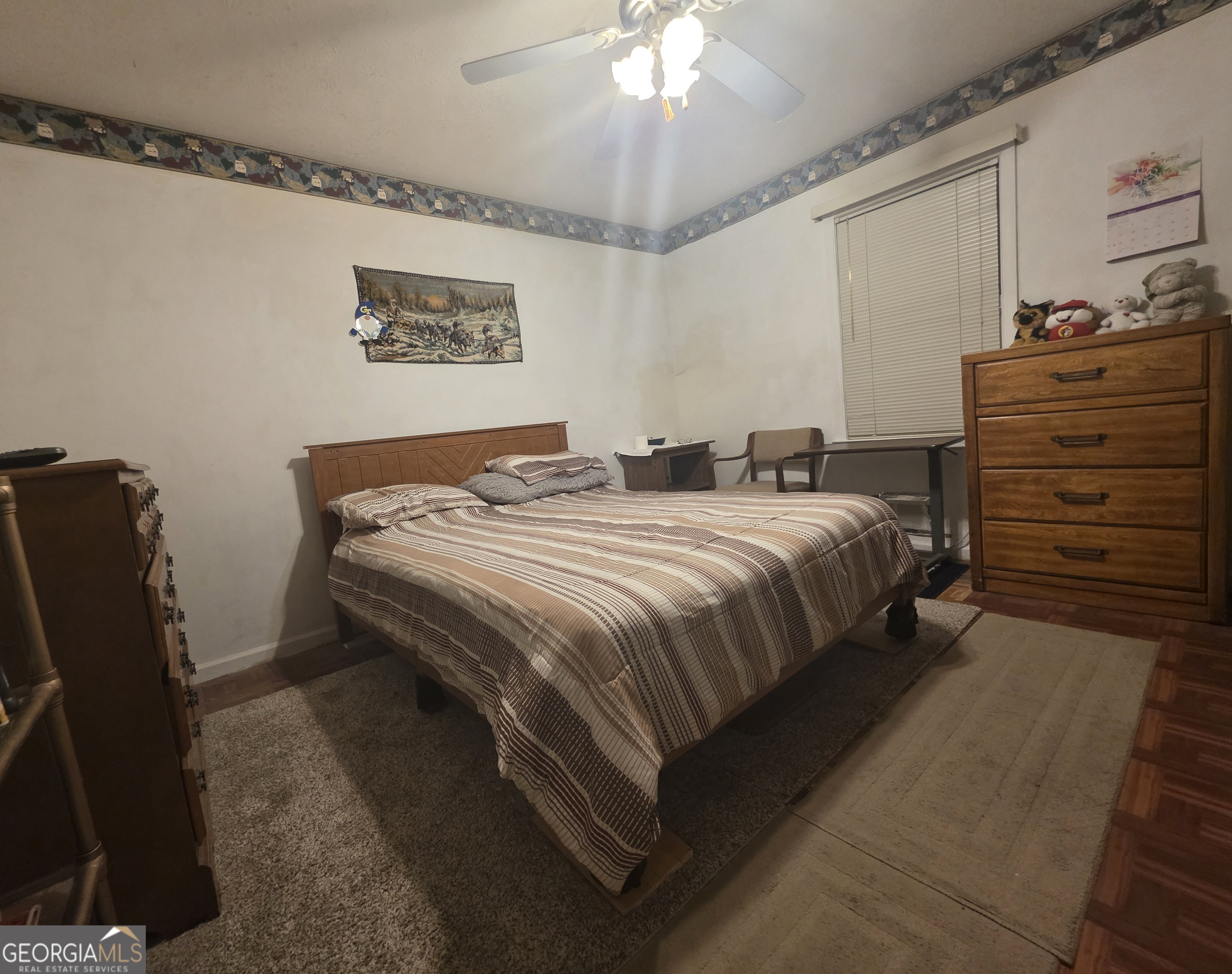 1407 Rainbow Circle Griffin, GA 30224 - Photo 15 of 23 a bedroom with a bed and a chandelier