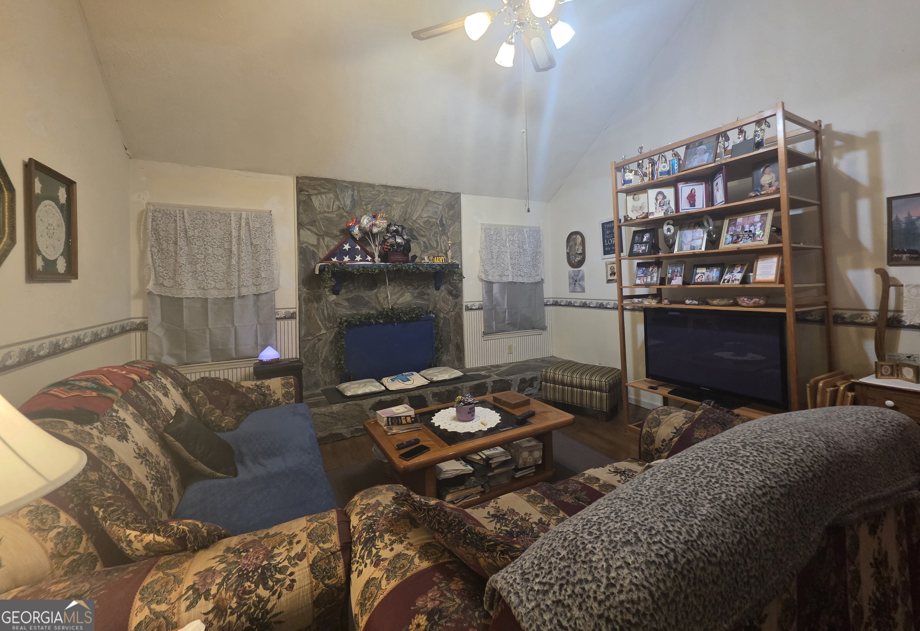 1407 Rainbow Circle Griffin, GA 30224 - Photo 6 of 23 a living room with furniture a rug and a bookshelf