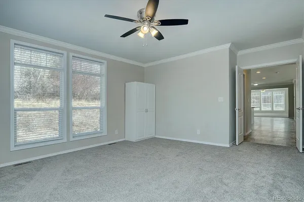 a view of empty room with ceiling fan