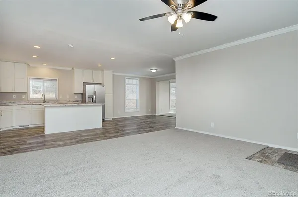 a view of kitchen with refrigerator and window