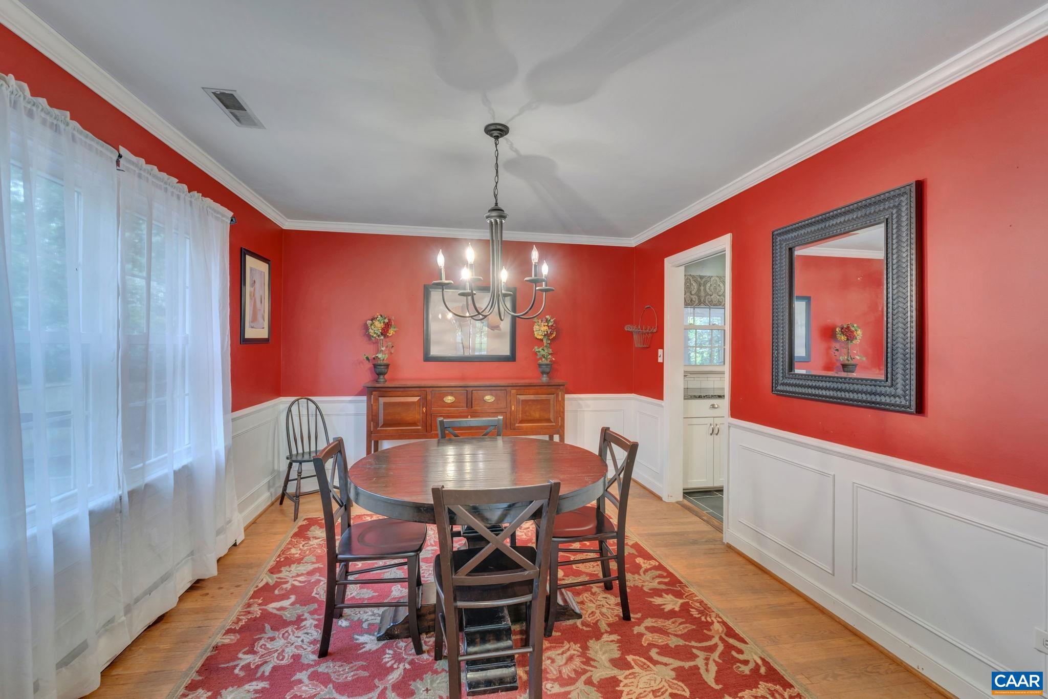 1717 Solomon Road Charlottesville, VA 22901 - Photo 13 of 41 a dining room with furniture a chandelier and wooden floor