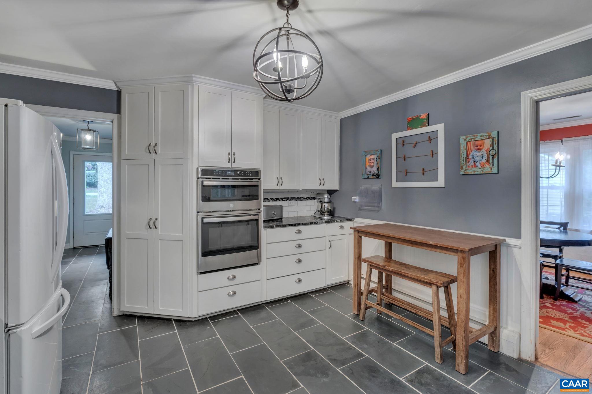 1717 Solomon Road Charlottesville, VA 22901 - Photo 14 of 41 a kitchen with stainless steel appliances a stove cabinets and chairs