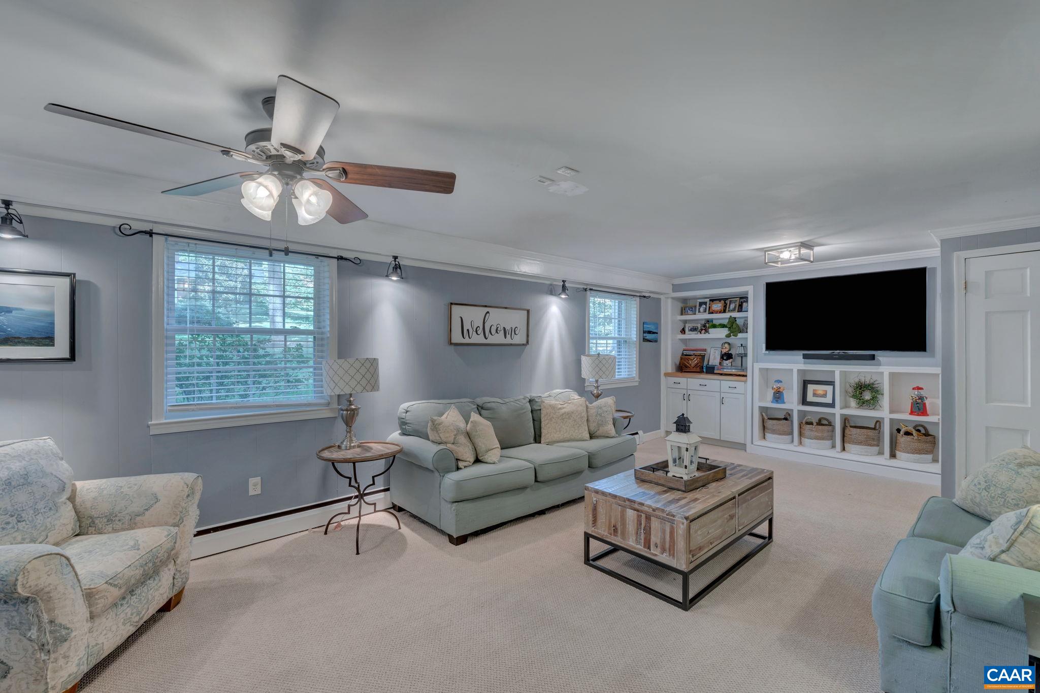 1717 Solomon Road Charlottesville, VA 22901 - Photo 26 of 41 a living room with furniture and a flat screen tv