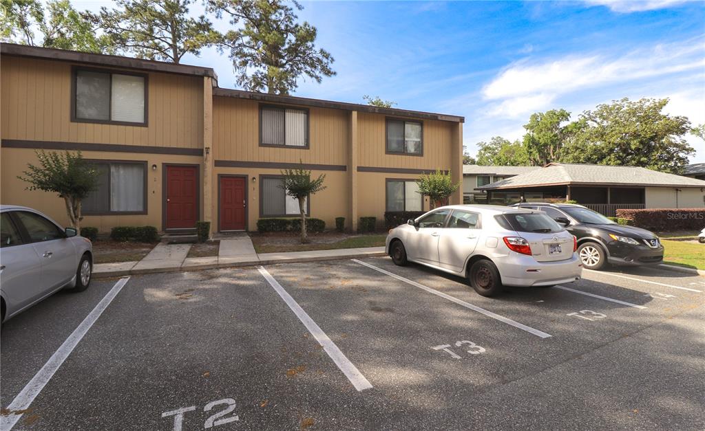 2300 Southwest 43rd Street, Unit T3 ROOM C Gainesville, FL 32607 - Photo 1 of 27 a white car parked in front of a house