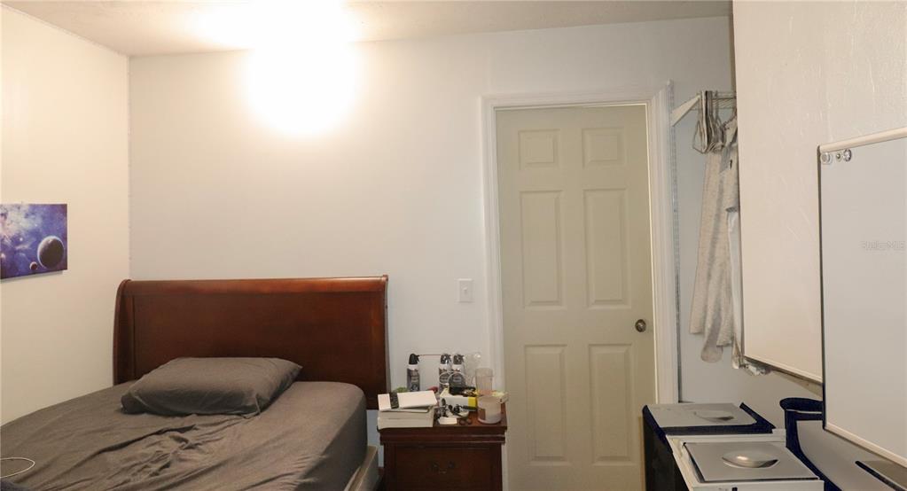 2300 Southwest 43rd Street, Unit T3 ROOM C Gainesville, FL 32607 - Photo 16 of 27 a living room with furniture and a window