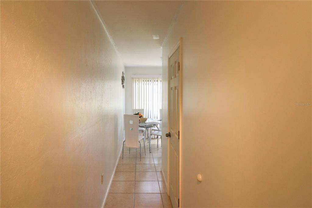 2300 Southwest 43rd Street, Unit T3 ROOM C Gainesville, FL 32607 - Photo 6 of 27 a view of a hallway with a chair and a table