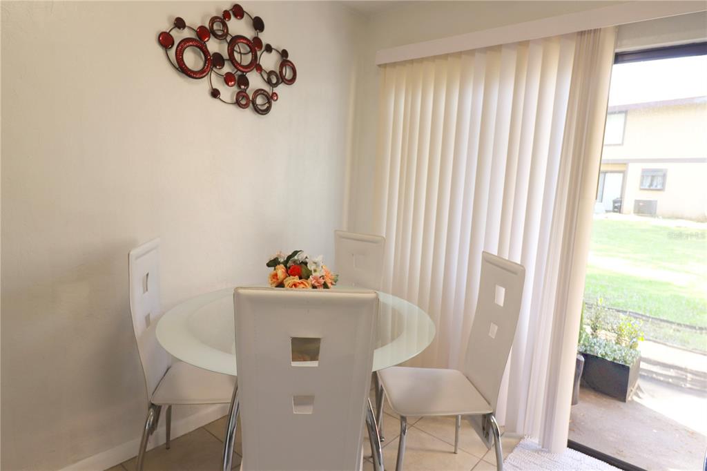 2300 Southwest 43rd Street, Unit T3 ROOM C Gainesville, FL 32607 - Photo 8 of 27 a view of a dining room with furniture window and outside view