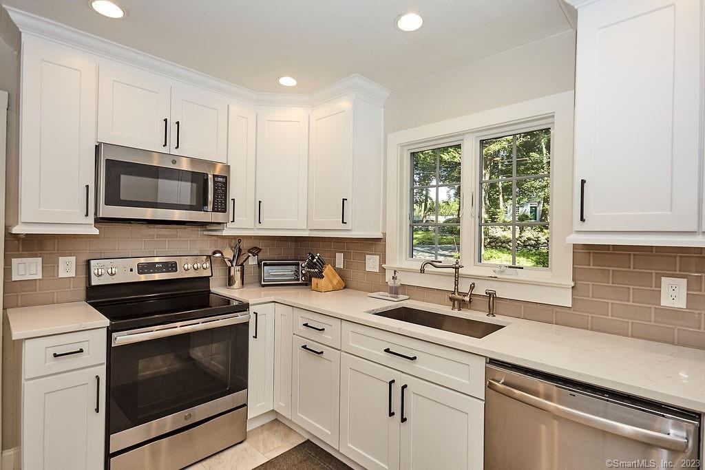94 Partrick Road Westport, CT 06880 - Photo 9 of 17 a kitchen with stainless steel appliances granite countertop a sink a stove a microwave and cabinets