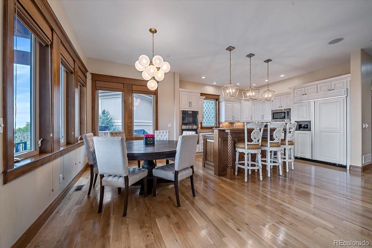 1254 Buffalo Ridge Road Castle Pines, CO 80108 - Photo 12 of 40 a view of a dining room with furniture window and wooden floor
