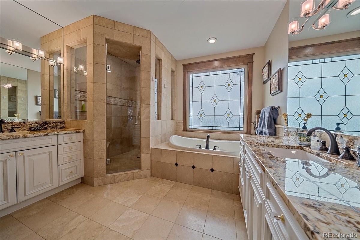 1254 Buffalo Ridge Road Castle Pines, CO 80108 - Photo 18 of 40 a bathroom with a granite countertop sink a toilet a mirror and shower