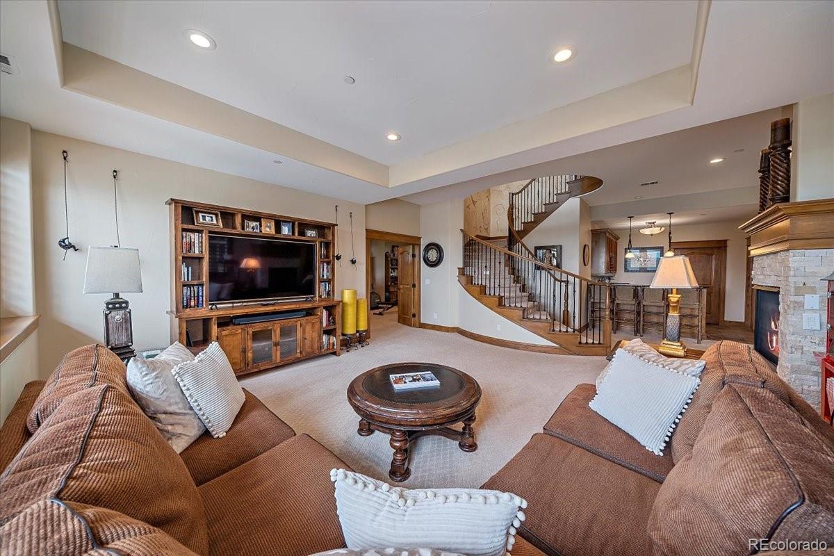 1254 Buffalo Ridge Road Castle Pines, CO 80108 - Photo 25 of 40 a living room with furniture and a flat screen tv