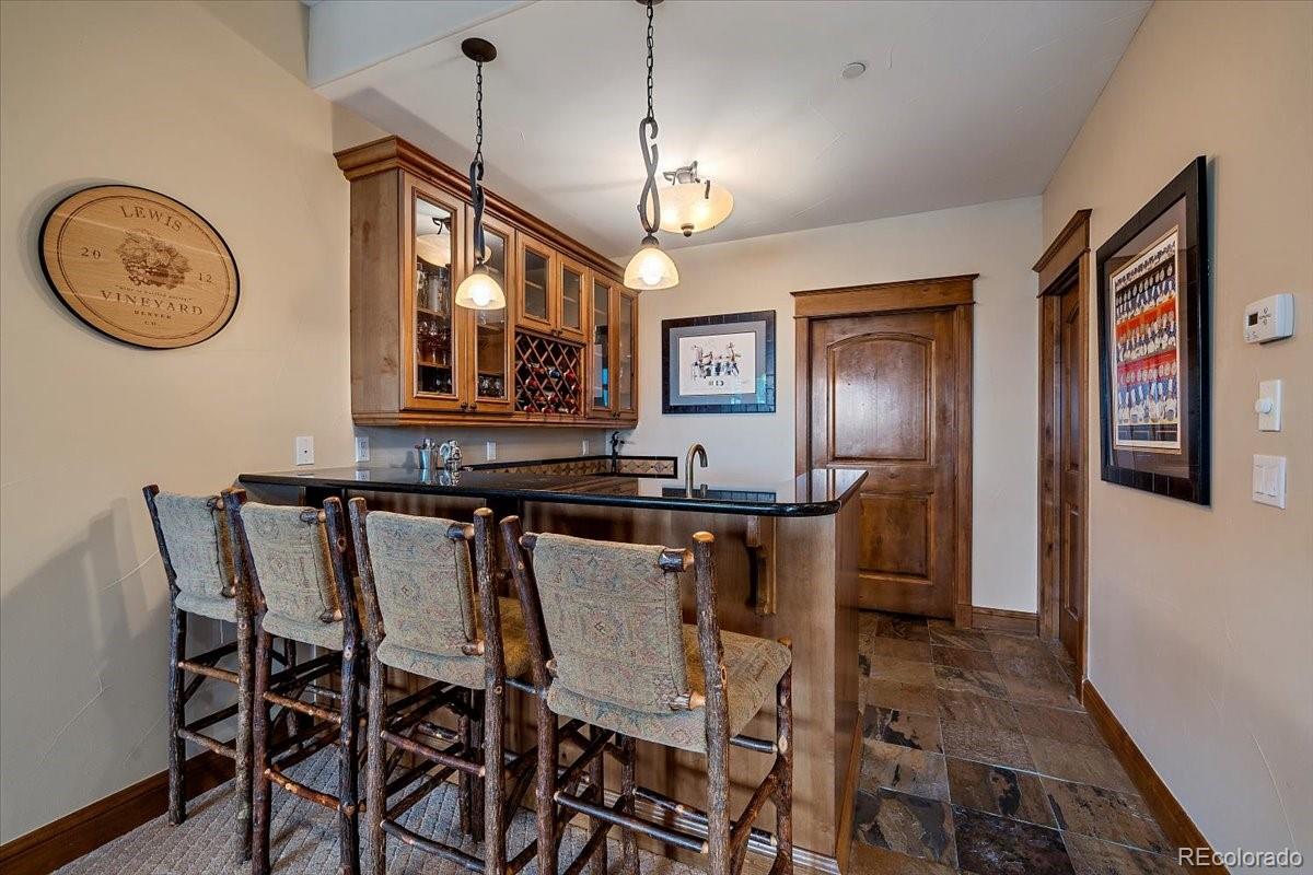 1254 Buffalo Ridge Road Castle Pines, CO 80108 - Photo 27 of 40 a view of a dining room with furniture and a chandelier