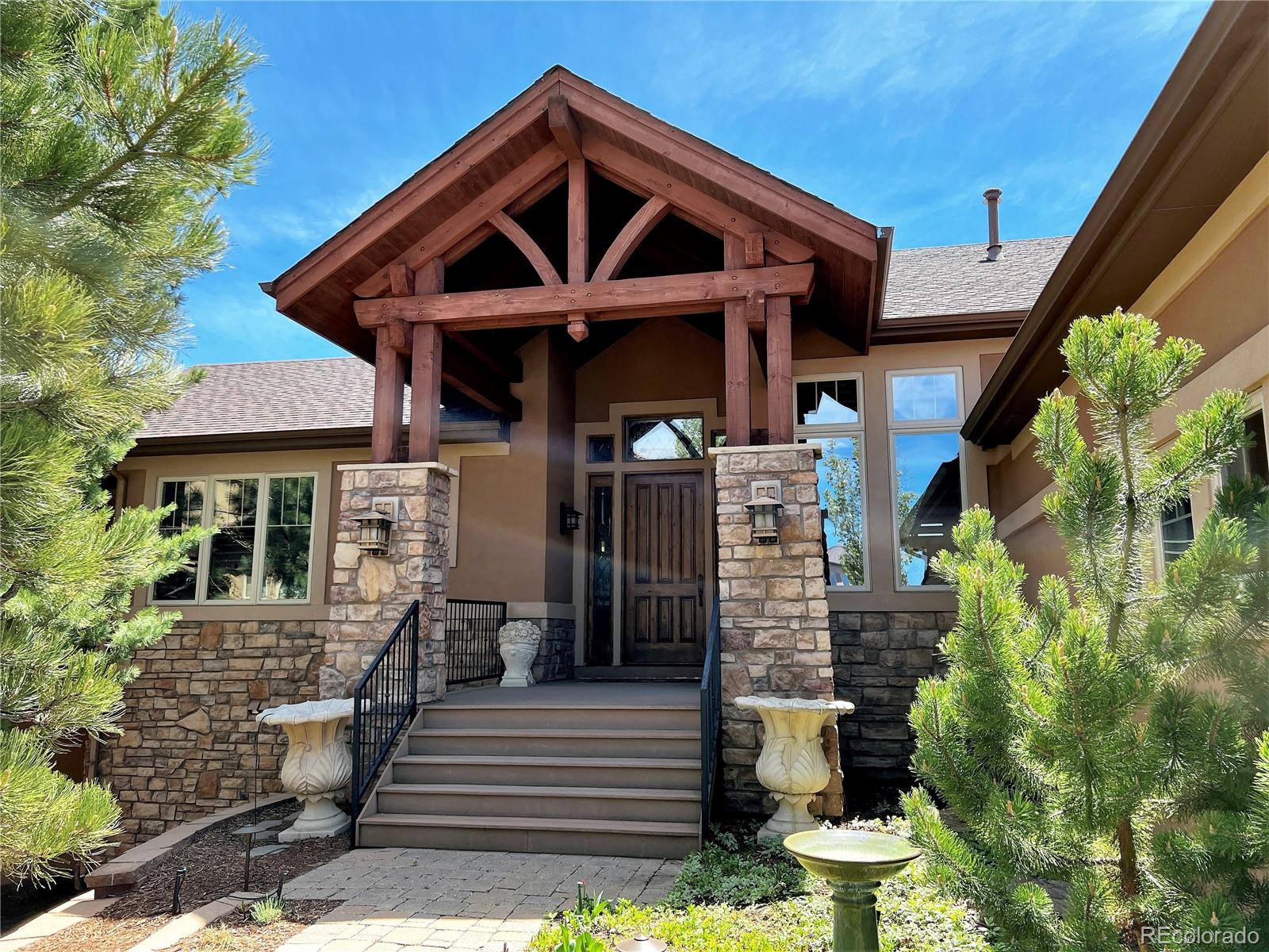 1254 Buffalo Ridge Road Castle Pines, CO 80108 - Photo 3 of 40 a front view of a house with a yard