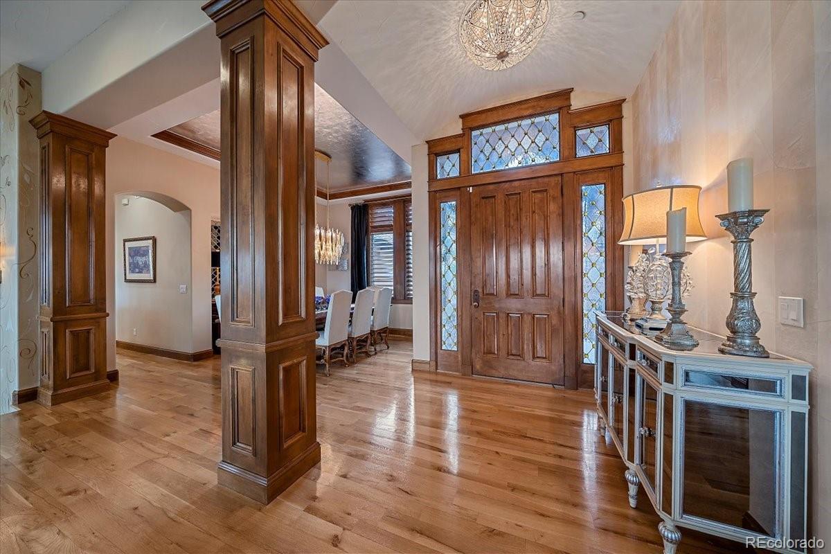 1254 Buffalo Ridge Road Castle Pines, CO 80108 - Photo 4 of 40 a view of a hallway with wooden floor and entryway
