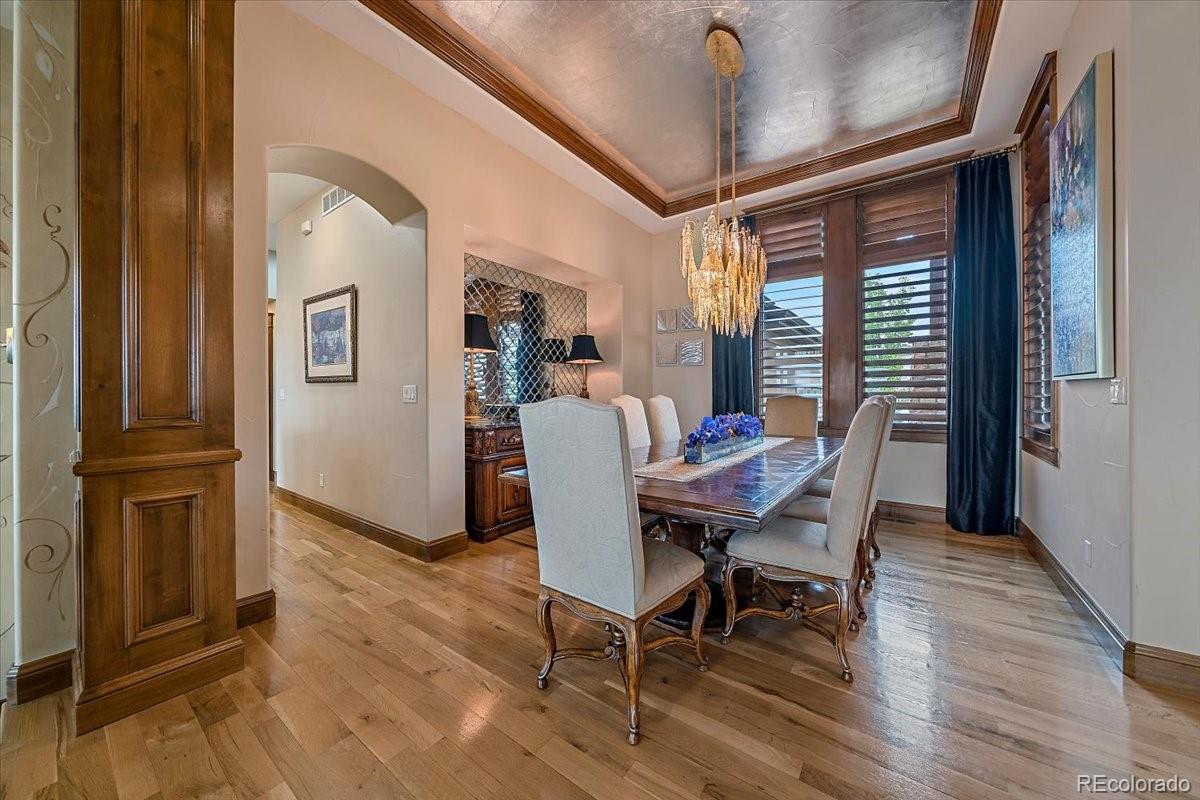1254 Buffalo Ridge Road Castle Pines, CO 80108 - Photo 6 of 40 a view of a dining room with furniture window and wooden floor