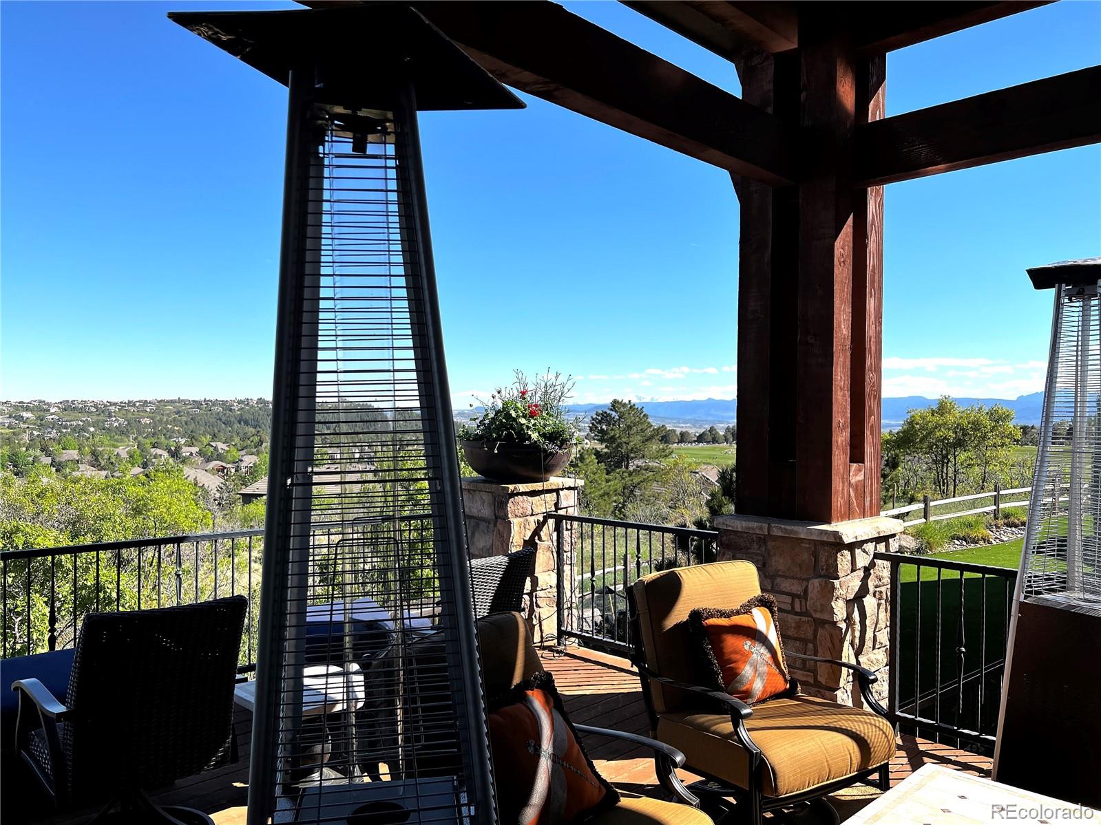 1254 Buffalo Ridge Road Castle Pines, CO 80108 - Photo 10 of 40 a view of a balcony with chair and wooden floor