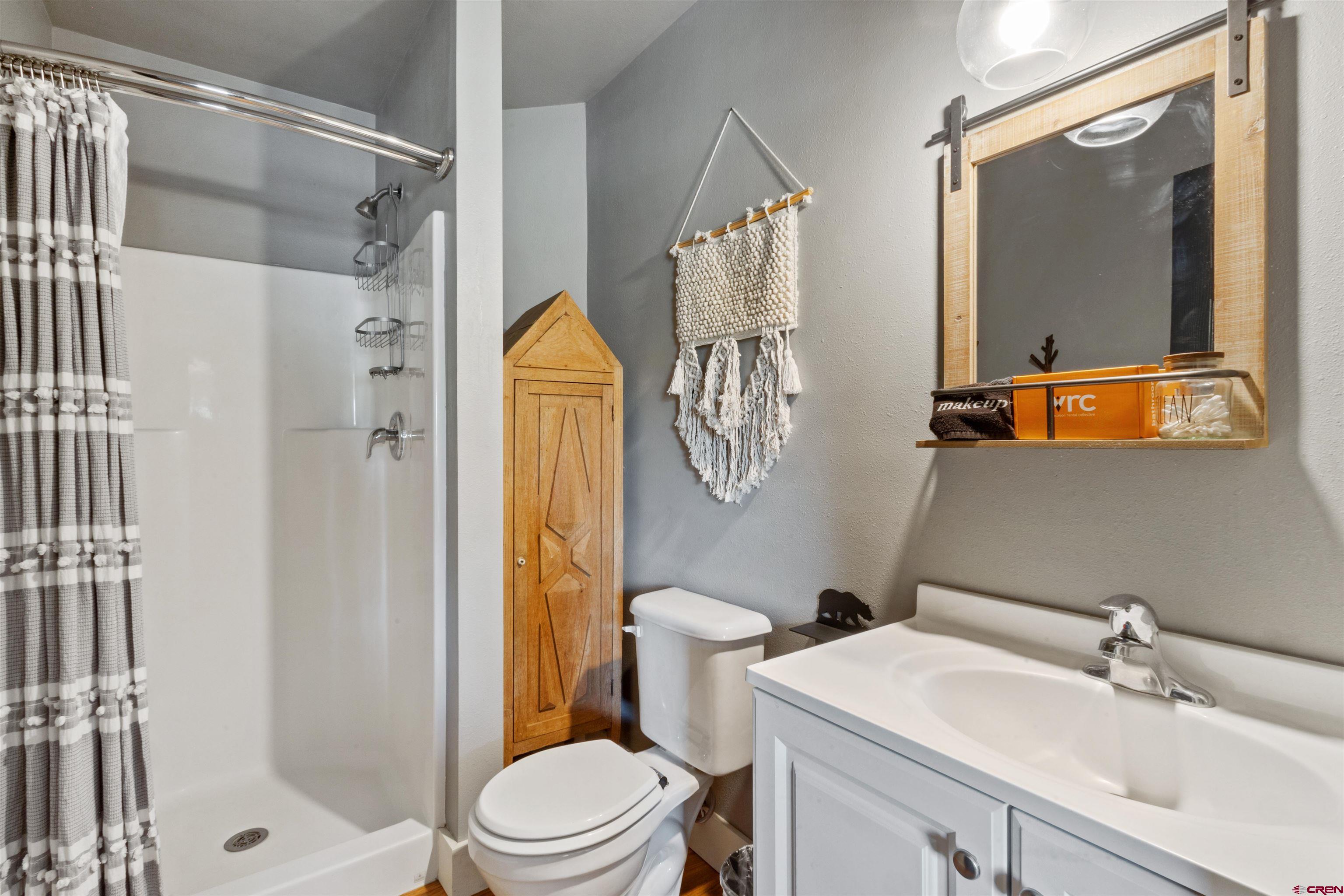 301 West 3rd Street Creede, CO 81130 - Photo 14 of 28 a bathroom with a sink toilet and shower