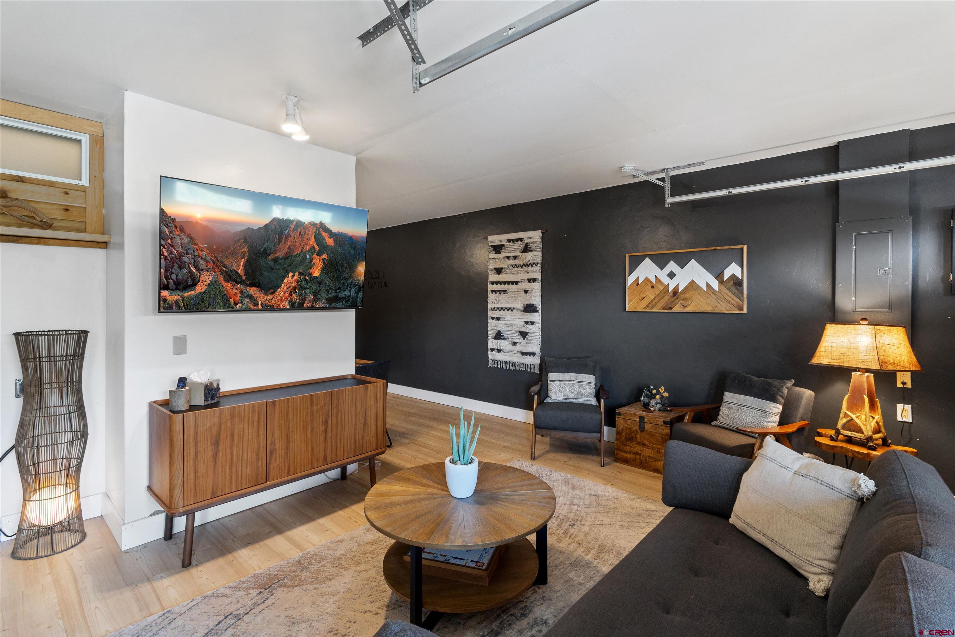 301 West 3rd Street Creede, CO 81130 - Photo 16 of 28 a living room with furniture and a flat screen tv