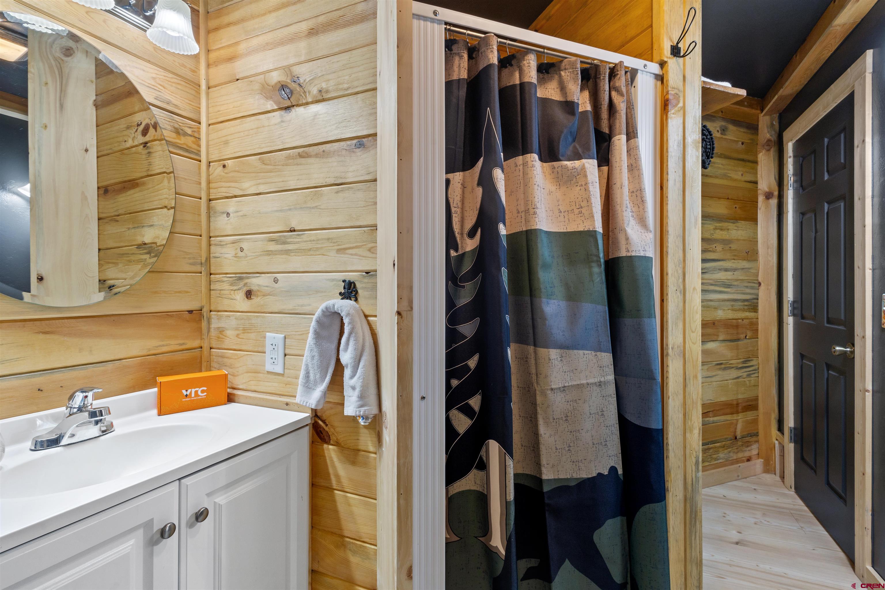 301 West 3rd Street Creede, CO 81130 - Photo 19 of 28 a bathroom with a sink and mirror with shower
