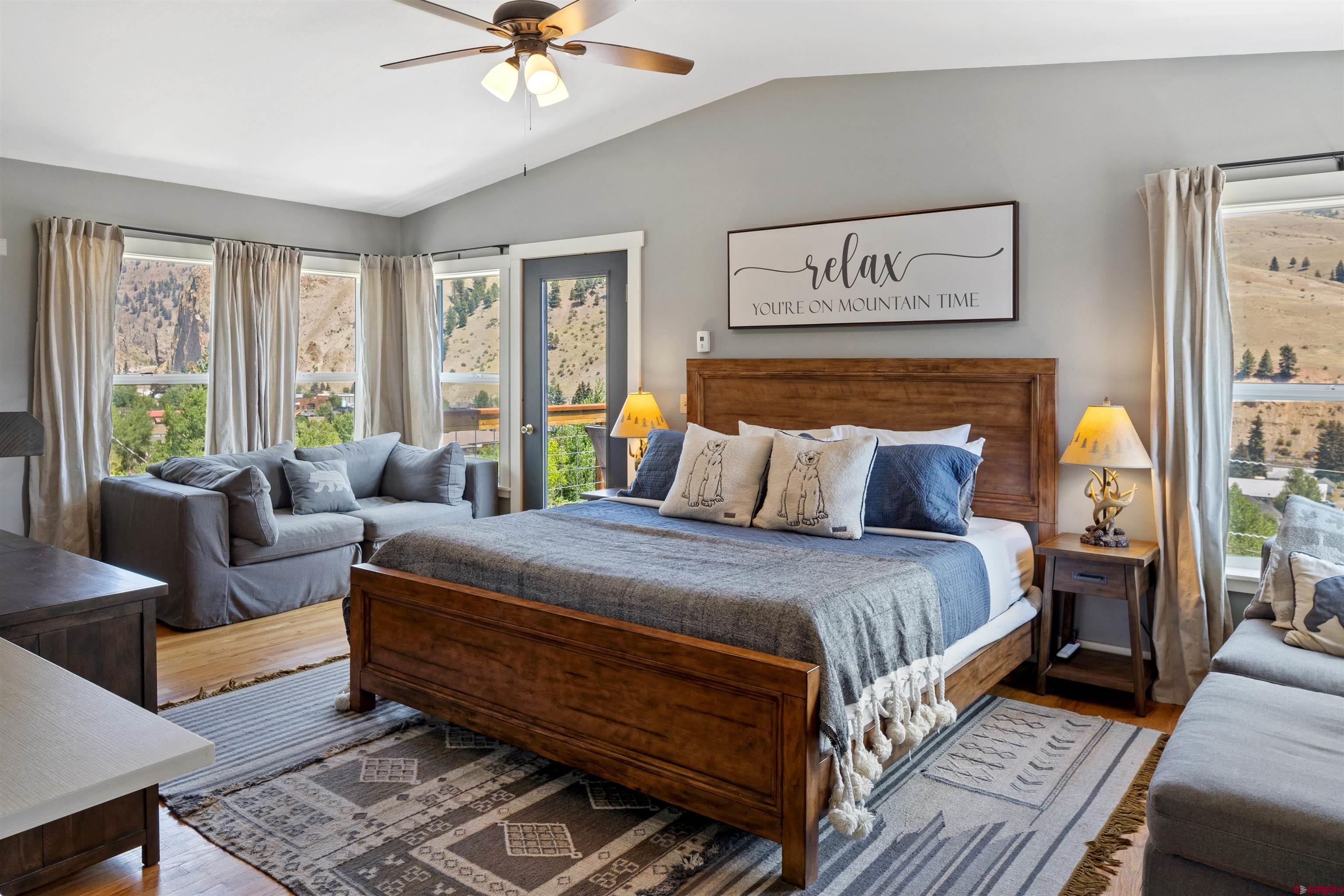 301 West 3rd Street Creede, CO 81130 - Photo 8 of 28 a bedroom with a bed and a couch