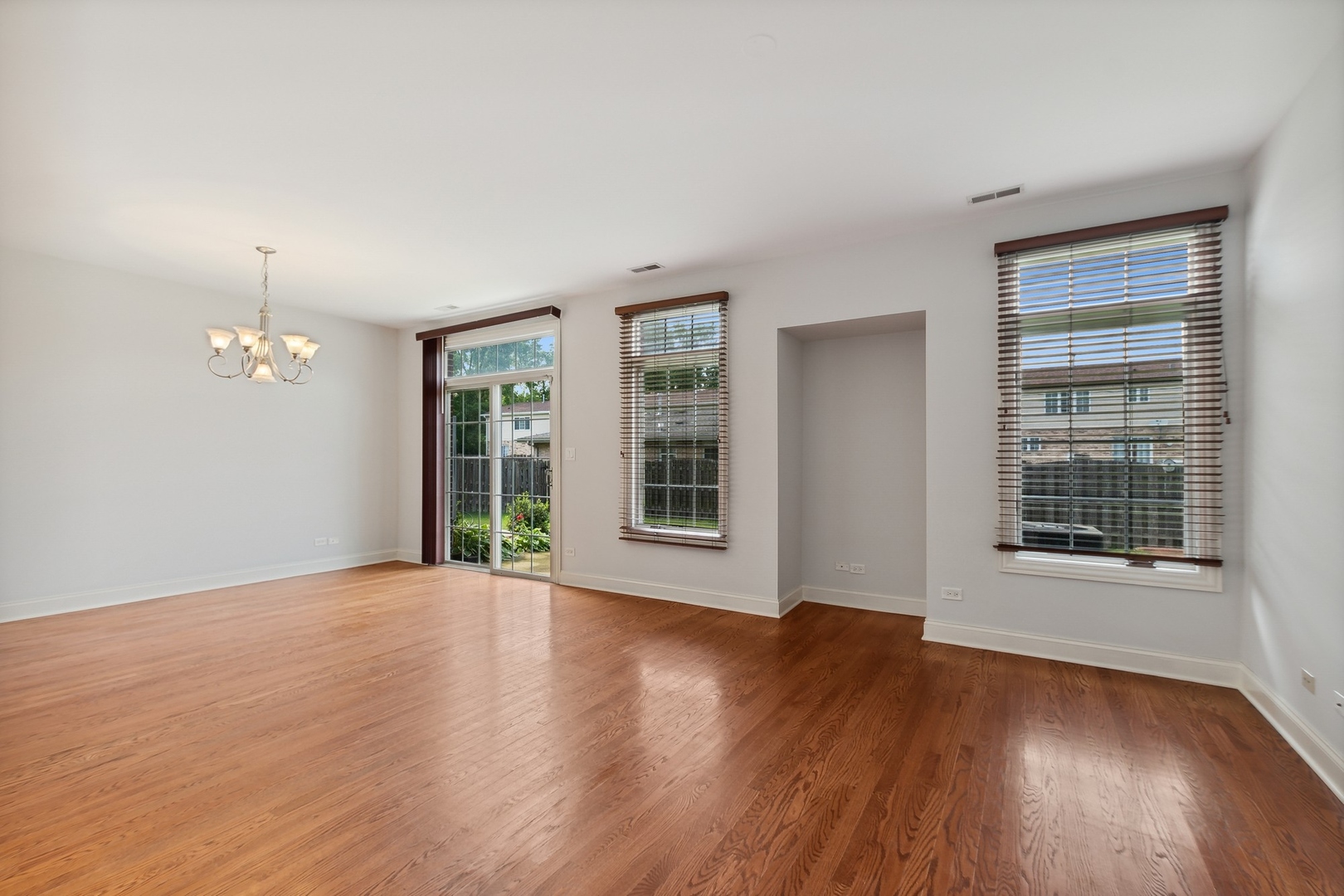 10028 South Roberts Road Palos Hills, IL 60465 - Photo 4 of 15 a view of an empty room with wooden floor and a window