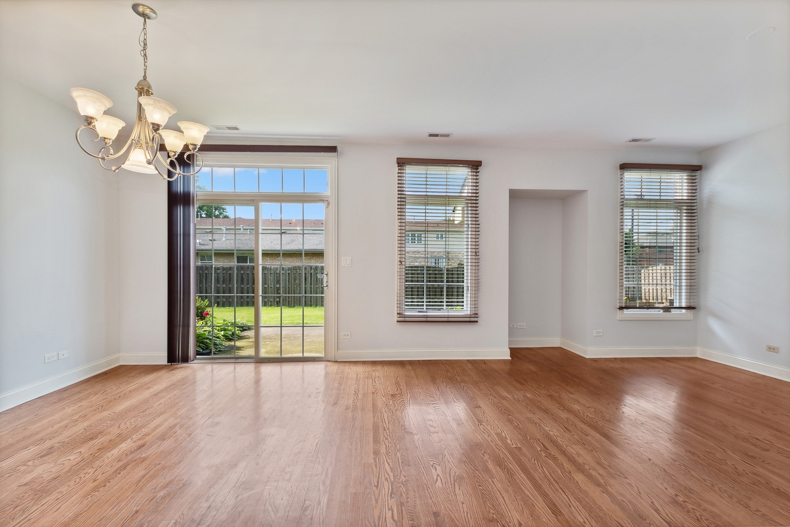 10028 South Roberts Road Palos Hills, IL 60465 - Photo 5 of 15 a view of an empty room with wooden floor and a window