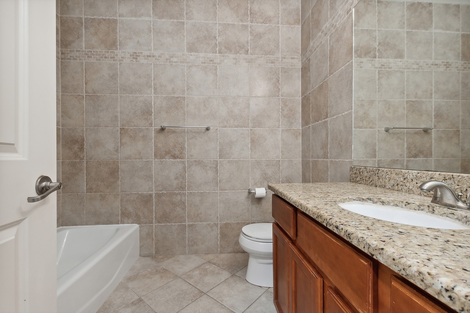 10028 South Roberts Road Palos Hills, IL 60465 - Photo 10 of 15 a bathroom with a granite countertop sink a toilet and bathtub