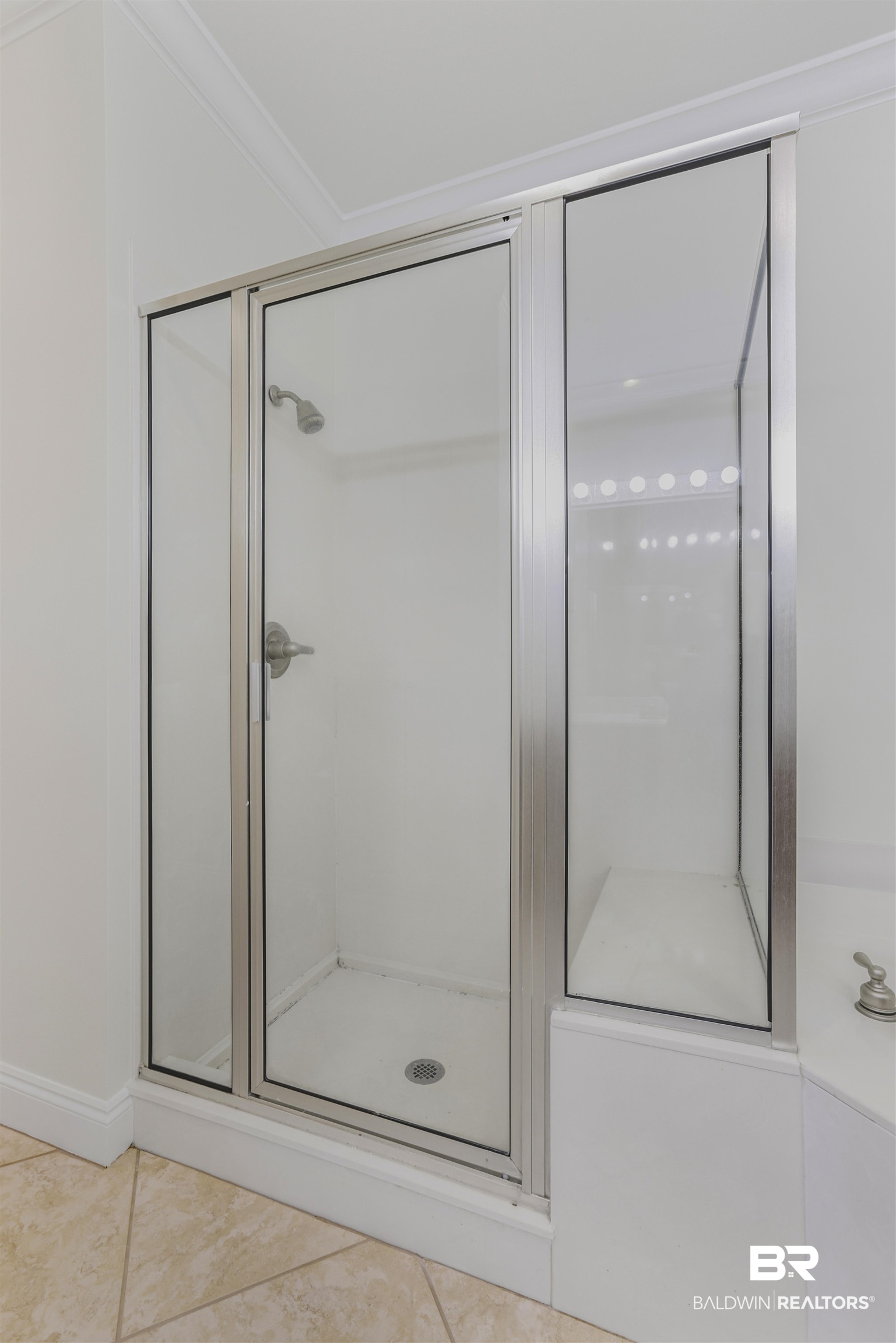 28250 Canal Road, Unit 106 Orange Beach, AL 36561 - Photo 14 of 50 Bathroom featuring ornamental molding, a shower stall, and light tile patterned flooring