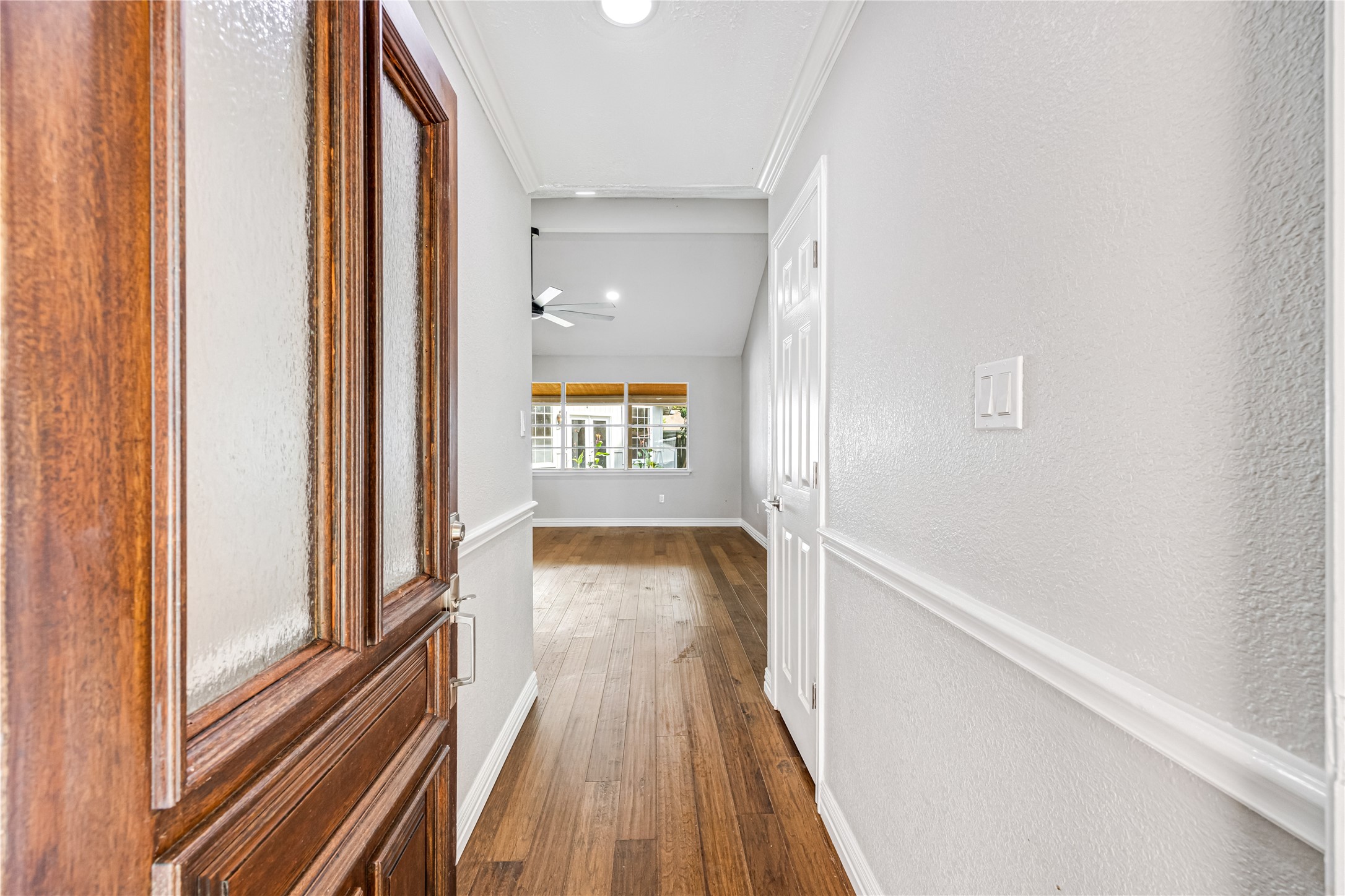 9806 Tanager Lane Conroe, TX 77385 - Photo 6 of 28 a view of a hallway with wooden floor and staircase