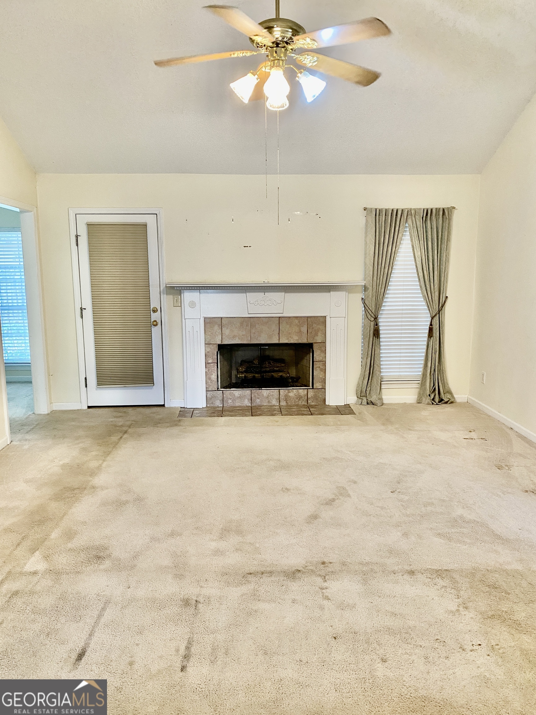 38 Boulder Drive Northwest Rome, GA 30165 - Photo 3 of 21 an empty room with chandelier fan and fireplace
